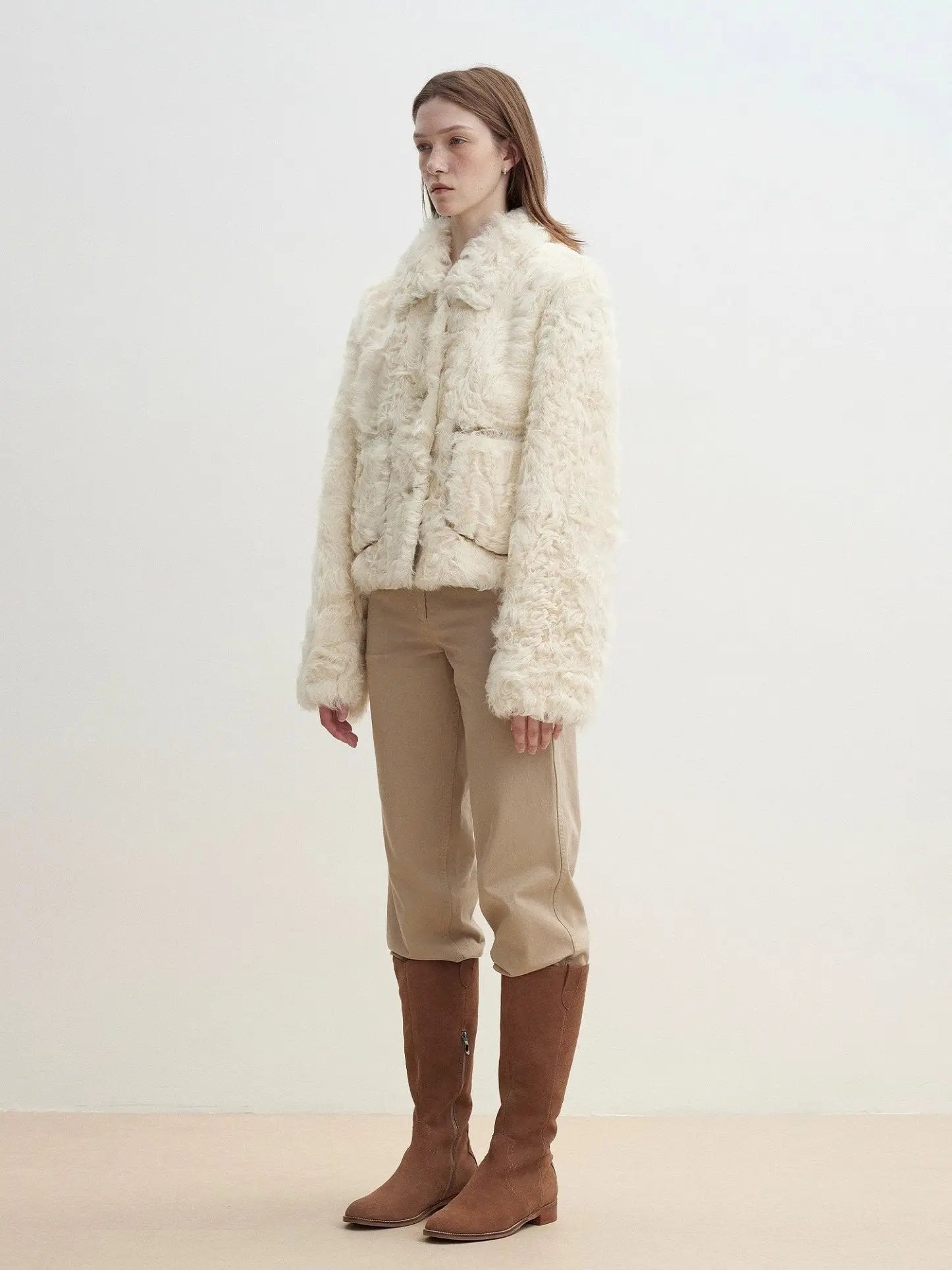 Model wearing the Rachel off-white two-tone curly wool shearling coat, side view