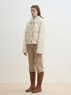 Model wearing the Rachel off-white two-tone curly wool shearling coat, side view