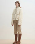 Model wearing the Rachel off-white two-tone curly wool shearling coat, side view