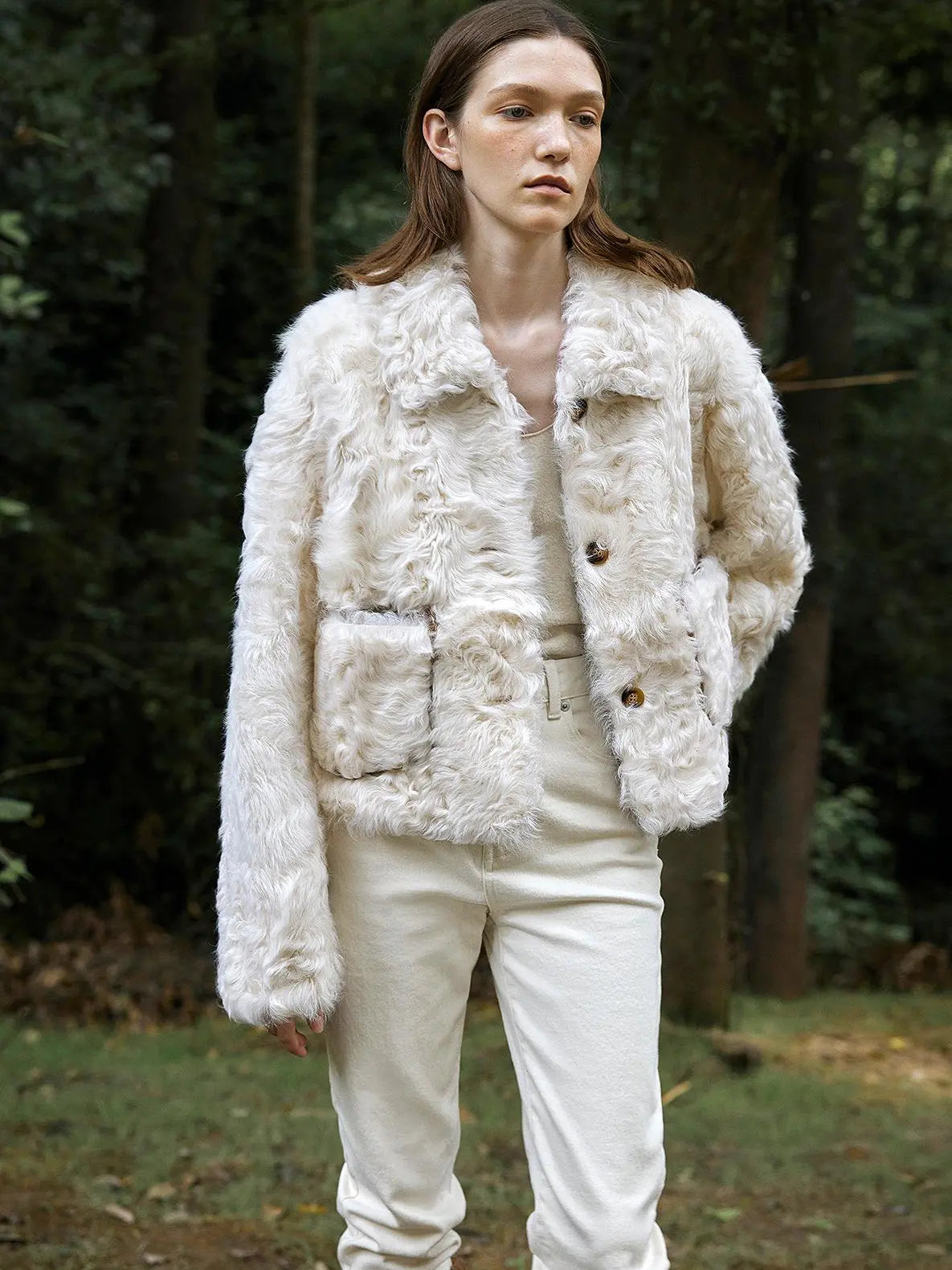Model styling the Rachel off-white two-tone curly wool shearling coat outdoors