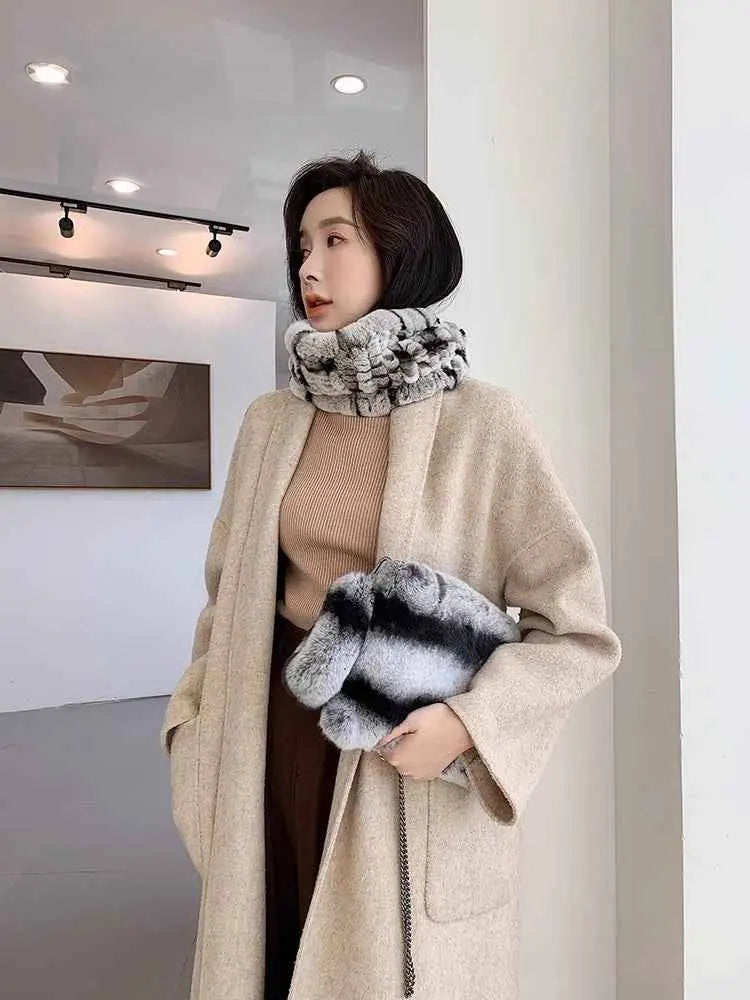 Woman styling a grey rex rabbit fur neck scarf with a neutral winter coat