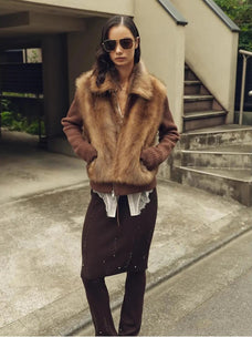 Model styling the Silky Cocoa amber brown shearling coat outdoors
