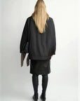 THE ARTM women's Black detachable fur collar nylon down parka back view on model