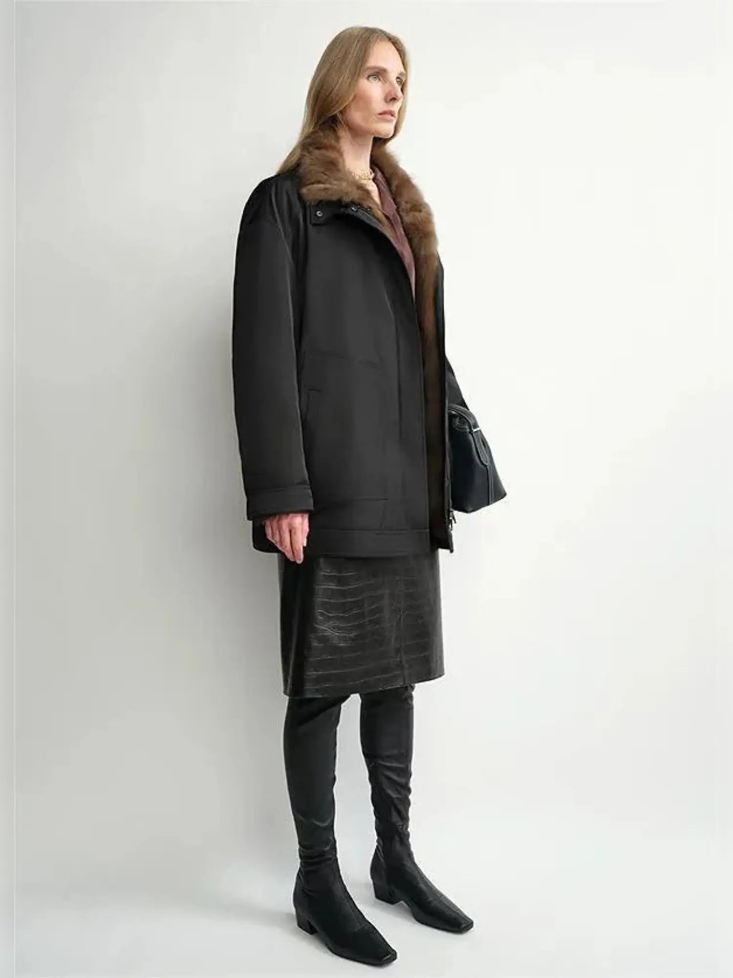 THE ARTM women's Black detachable fur collar nylon down parka side view on model