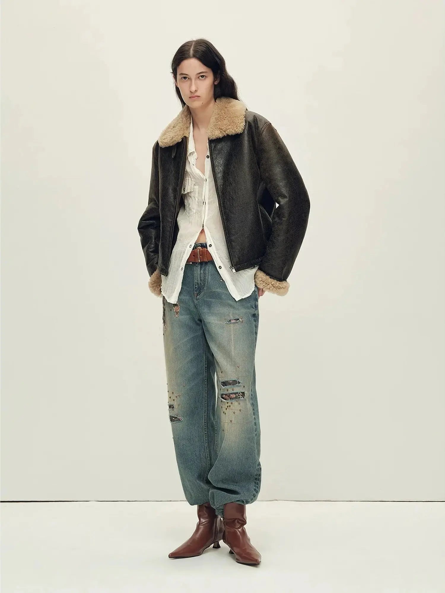 Woman wearing the Vintage Reverie crackled brown shearling jacket, full-length view