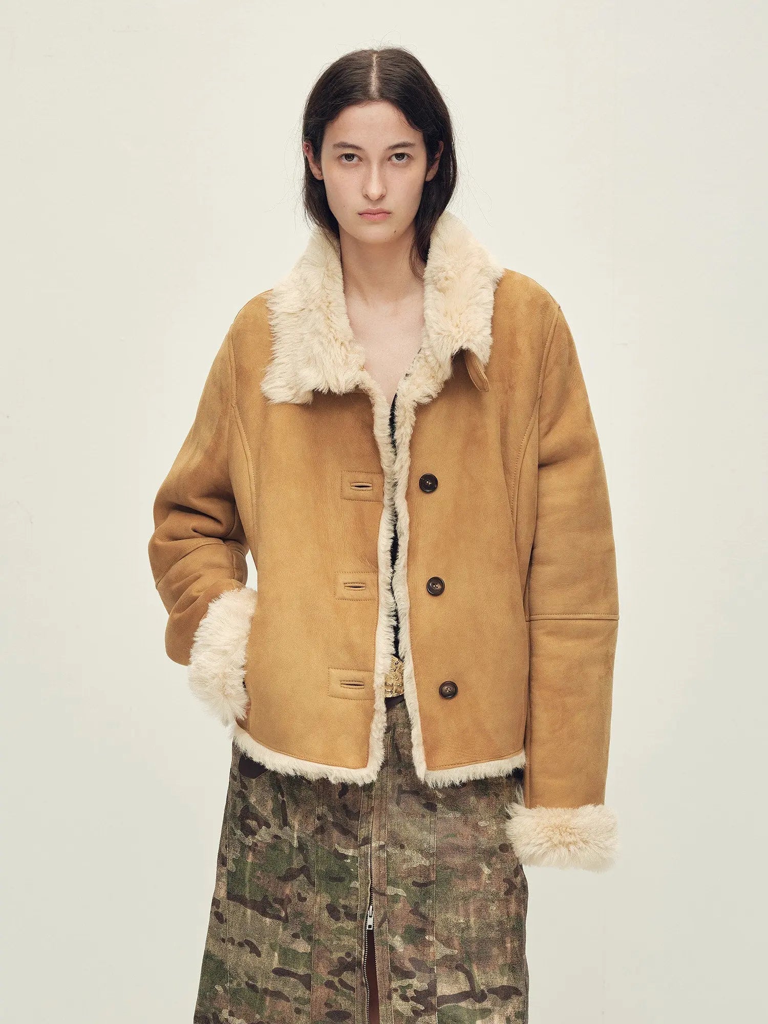 Woman wearing the Winter Mochi tea apricot shearling coat, front view