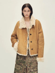 Woman wearing the Winter Mochi tea apricot shearling coat, front view