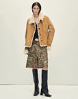 Woman styling the Winter Mochi tea apricot shearling coat, full-length view