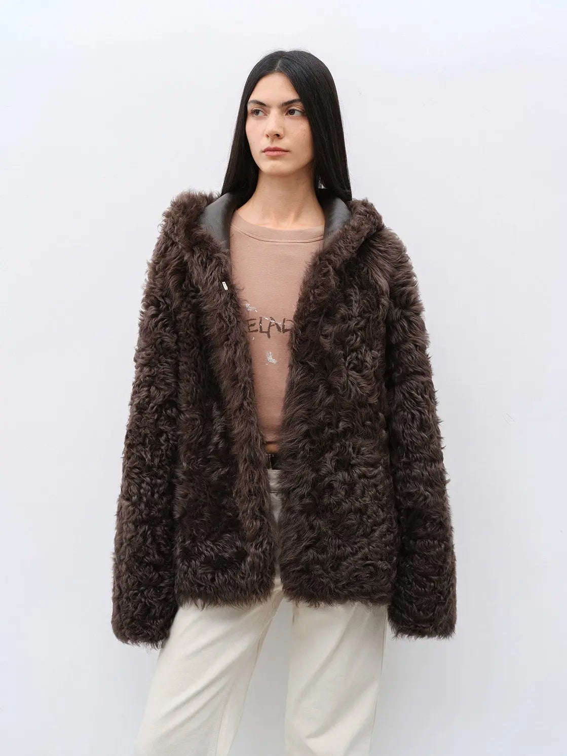 Woman wearing the Winter Snow brown hooded Toscana shearling coat, front view