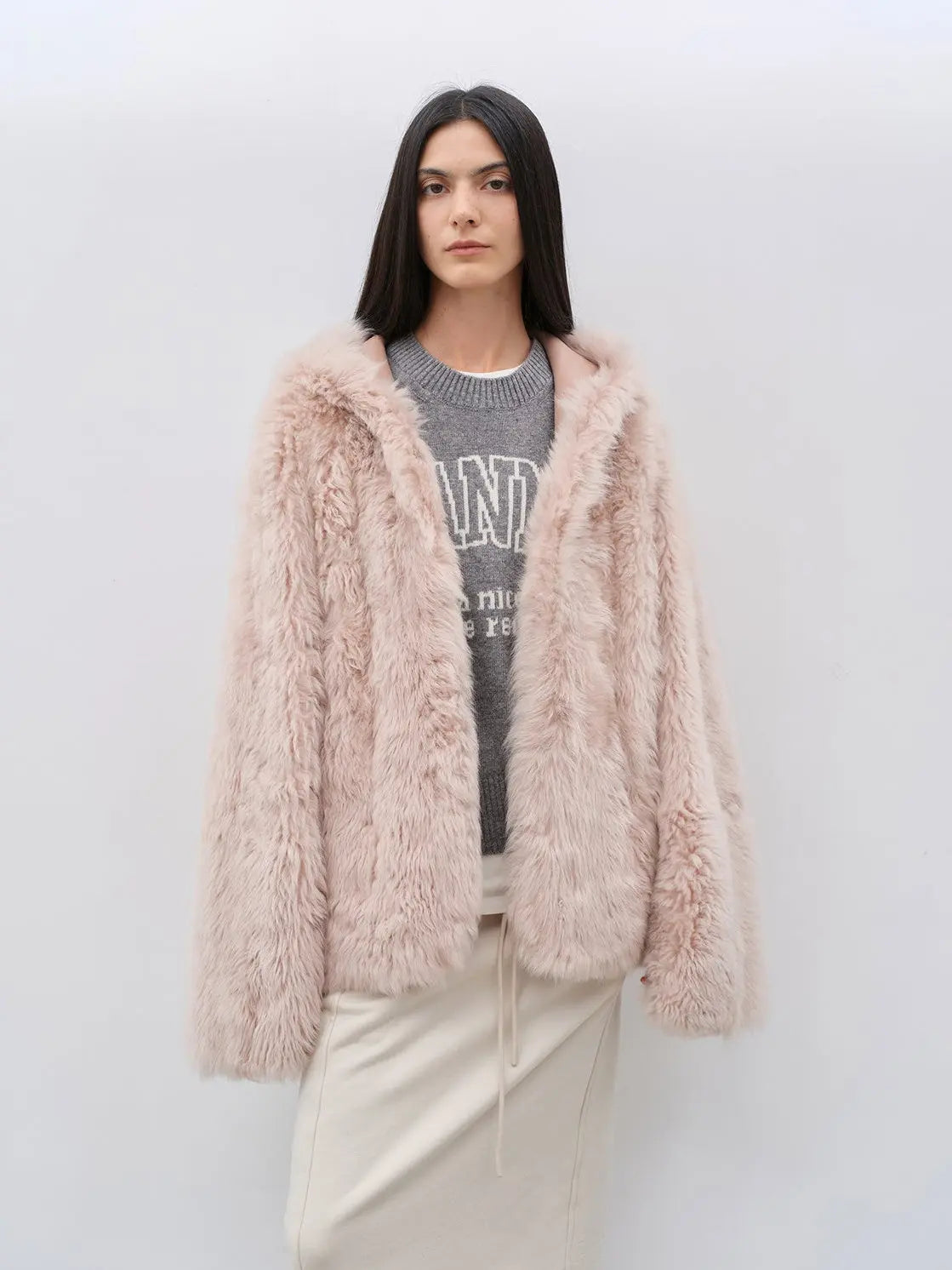 Woman wearing the Winter Snow dirty pink hooded Toscana shearling coat, front view