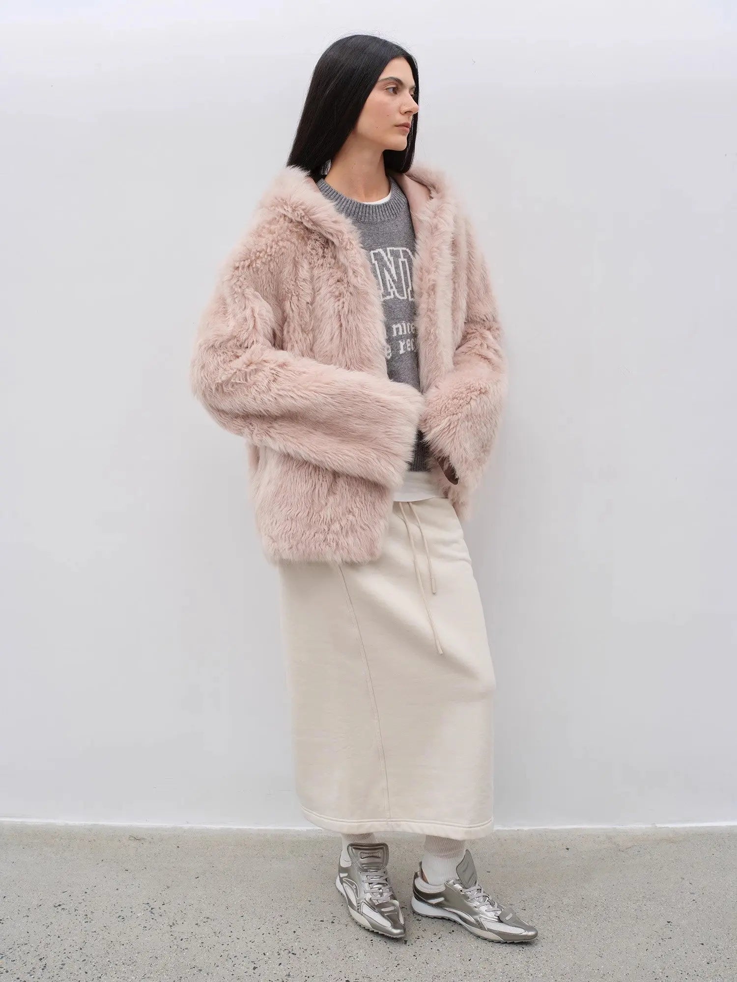 Woman styling the Winter Snow dirty pink hooded shearling coat, full-length view