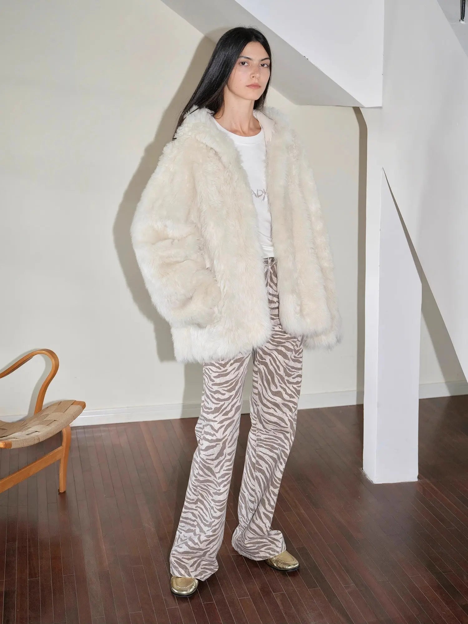 Woman styling the Winter Snow off-white Toscana shearling coat indoors