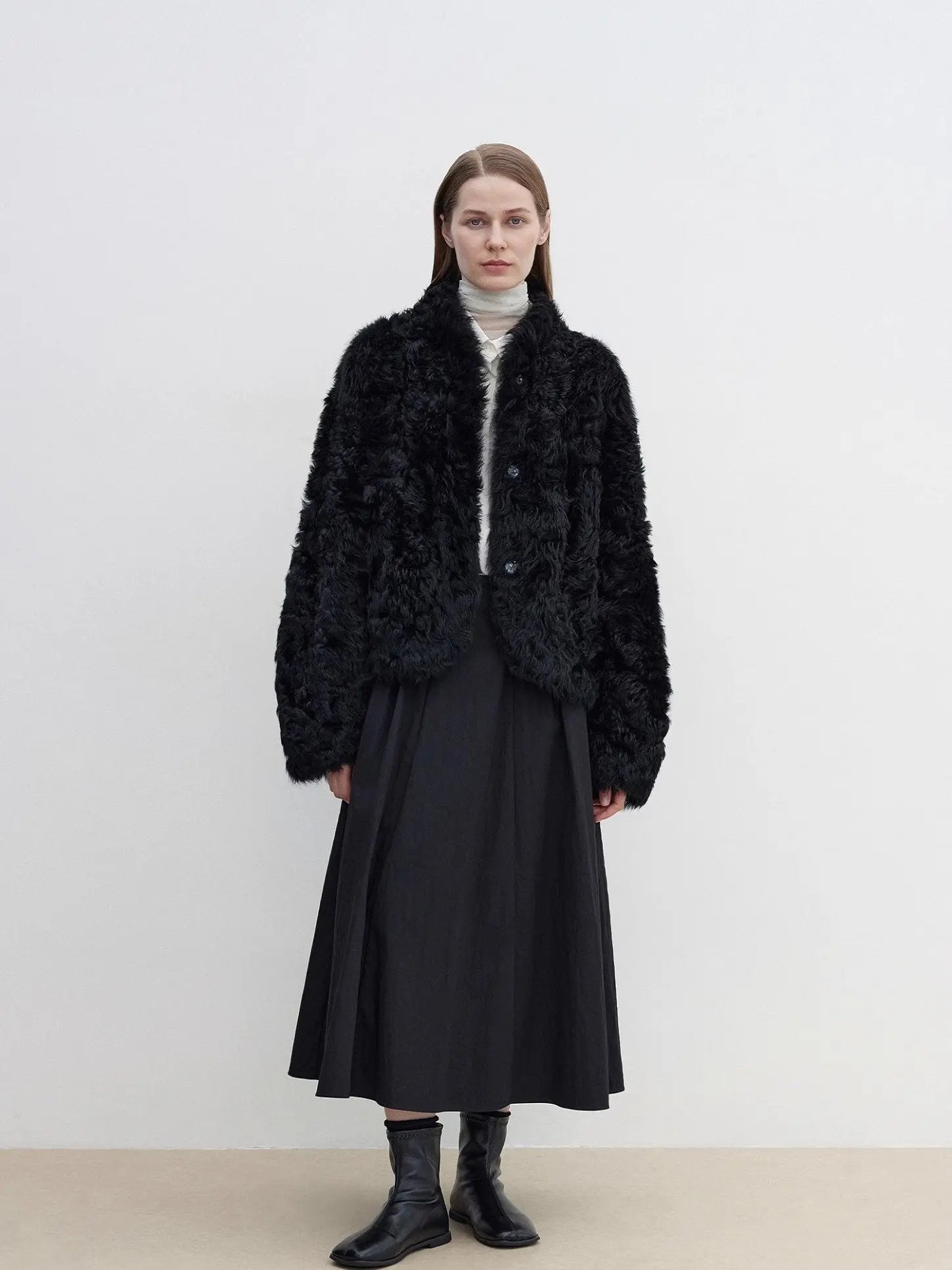 Yorta black curly shearling jacket with arc collar on model