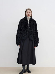 Yorta black curly shearling jacket with arc collar on model