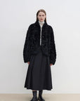 Yorta black curly shearling jacket with arc collar on model