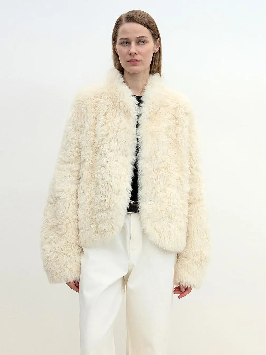 Model wearing the Yorta white Toscana curly shearling jacket