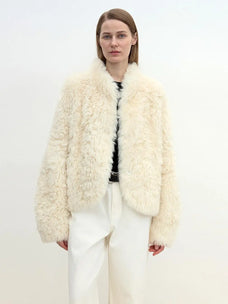 Model wearing the Yorta white Toscana curly shearling jacket
